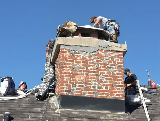 Millbury Chimney Sweep installing a custom chimney crown in Millbury, MA