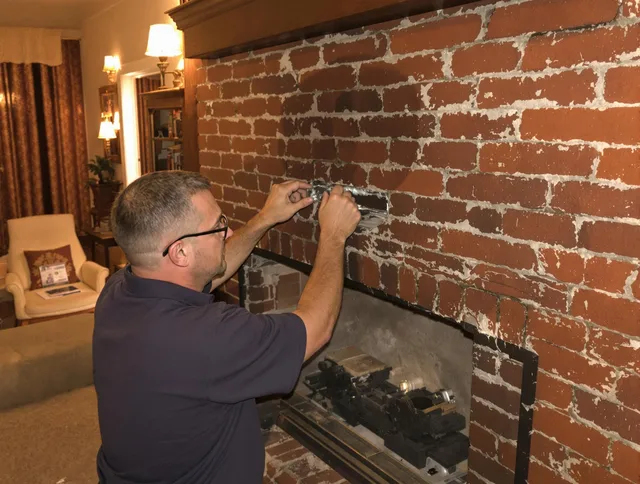 Millbury Chimney Sweep expert fixing a fireplace in Millbury, MA